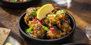 A selection of food in small dishes on top of a wooden table