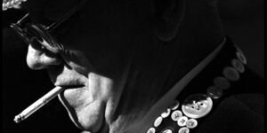 Black and white image of a man smoking.