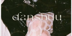 Image of a woman tying up her shoelaces, wearing a black jumper and tights.