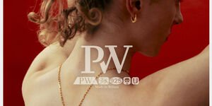 Image of a shirtless man tying his hair up in front of a red background.