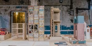 An image of a bookshelf and lego pieces in a studio space.