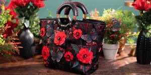 A black leather bag decorated with red leather flowers