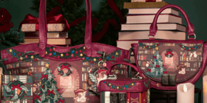 Three red leather bag decorated with Christmas scenes sit on top of a table covered with green velvet fabric