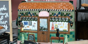 A rectangular bag decorated with a scene of a pie shop