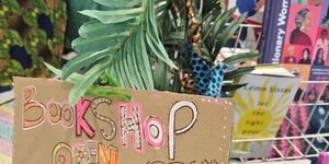 Image of a bookshop with a 'Bookshop Open' sign.