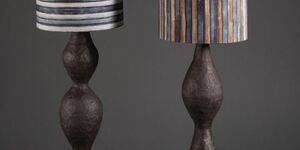 Image of two black ceramic spindle lamps.