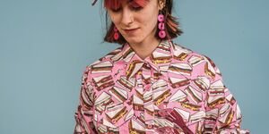 Image of a girl eating a hotdog.