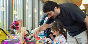 Father and Child looking at a stall