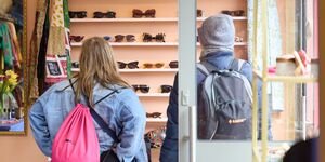 Image of two people looking at sunglasses.