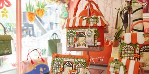 A shop display of brightly-coloured handbags