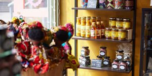 Image of a shelf displaying sauces, jars and mugs.