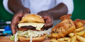 Image of Charles putting a burger on a tray.