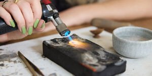 Image of someone using a blowtorch.