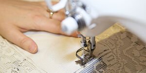 Image of Grace sewing on a sewing machine.