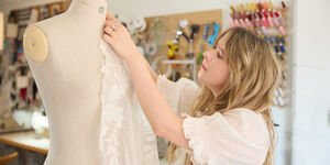 Image of Grace dressing a mannequin.