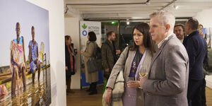 Image of two people looking at a photograph in the gallery.