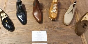 An image of a row of different coloured leather shoes.