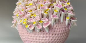 Image of a pink vase with flowers.