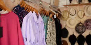A selection of women's clothing display on wooden hangers