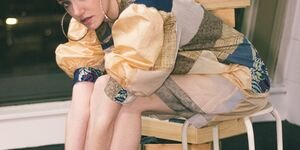 Image of a female model in a chair.