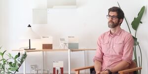 Image of Alex sat in a chair.