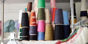 Rolls of colourful wool on a shelf