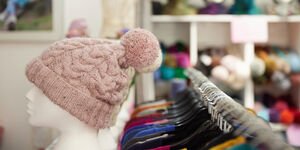 A mannequin wearng  a pink knitted hat