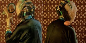 Image of two elderly women looking in a mirror.