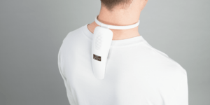 Image of a man wearing a device on the back of his neck.