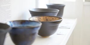 A white shelf lined with ceramic bowls