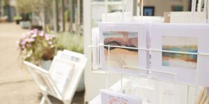 A rack outside filled with prints and cards