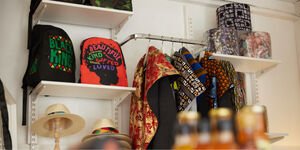 White shelves hold colourful bags and textiles