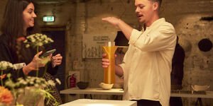 Image of a man talking about an art piece.