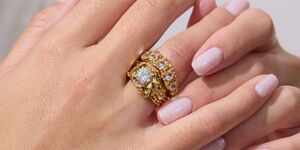Image of two hands modelling wedding rings.