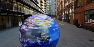 Portrait image of the globe in front of the galleries.