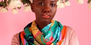 Image of a woman modelling a colourful scarf.