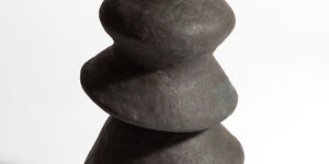 Image a large black ceramic vase.