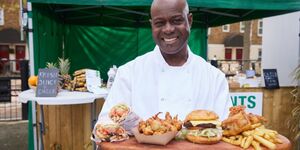 Image of owner Charlies Diallo holding a tray of food.