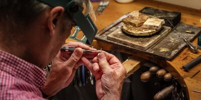 An image of David Ashton creating his jewellery in his studio.