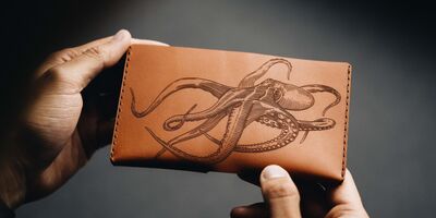 Image of a leather wallet with an octopus illustration on the front.