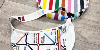 Image of a sling bag with the London Underground map printed on it.
