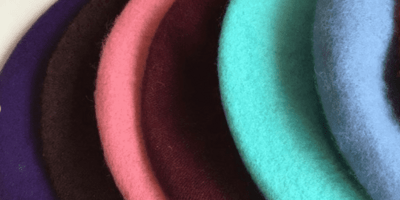 Image of a row of colourful berets.