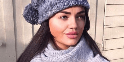 Image of a woman wearing a grey hat and scarf.