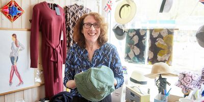 Image of Janice holding a hat in her shop.