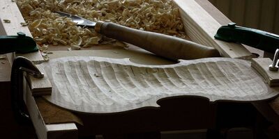 Image of a carved out wooden violin.