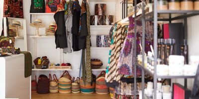 A photo of a shop interior with colourful baskets on the floor and shelves lined with objects
