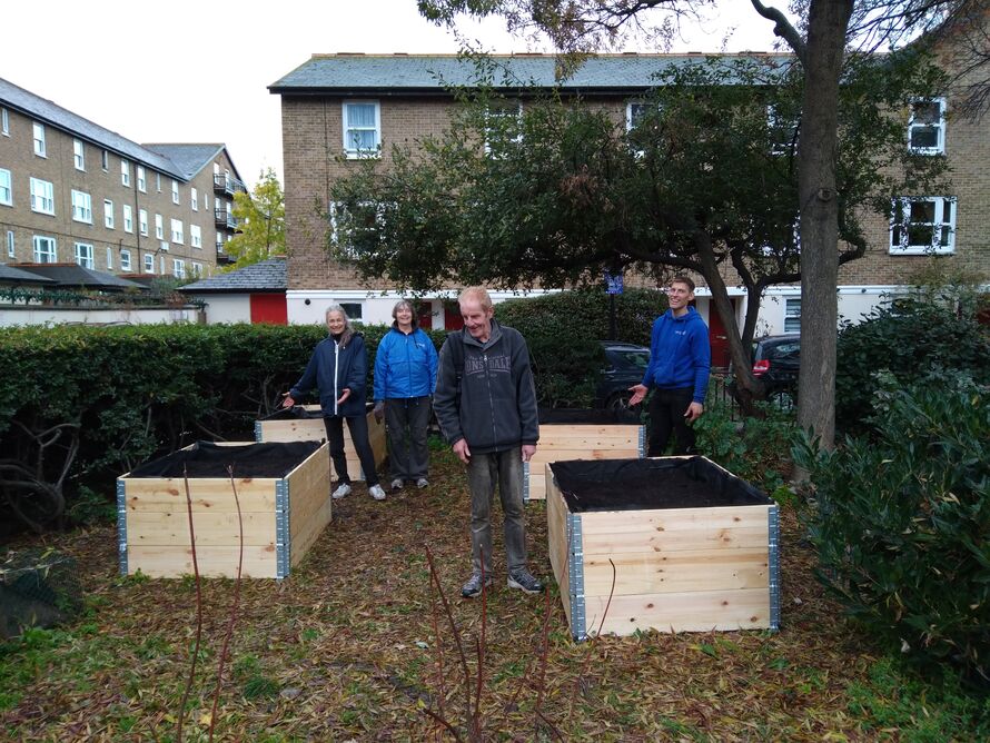Our gentle gardening group standing next to the new raised beds