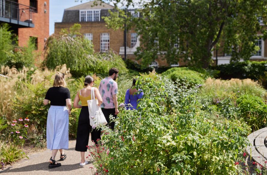 Image of a group of people walking through Bernie Spain Gardens.
