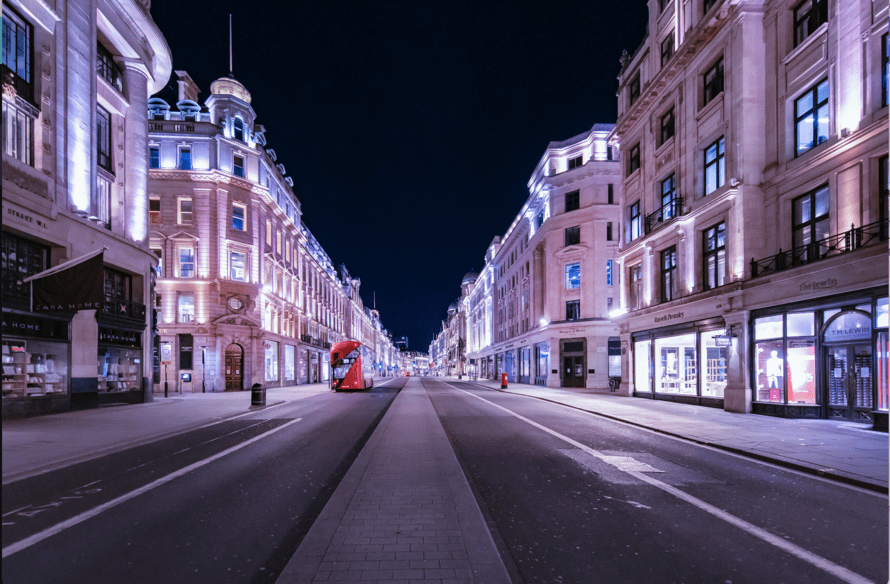 A bus drives down the empty streets of Central London
