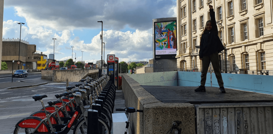 Jaemii-Lee in front of the billboard on waterloo bridge